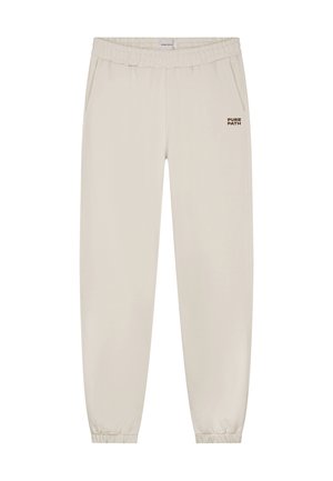 Helle beigefarbene Jogginghose aus weichem Stoff mit einem elastischen Bund, Seitentaschen und einem kleinen "PURE PATH"-Logo auf der Vorderseite.