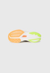 Suela de zapato con una base blanca y acentos en naranja, verde y amarillo. Un patrón de tacos que incluye surcos y diseños circulares para mayor tracción.