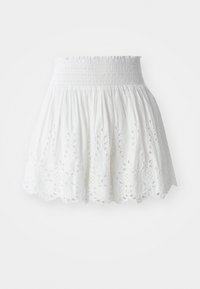 Jupe en coton blanc avec une taille smockée, ornée de découpes florales brodées le long de l'ourlet et d'une silhouette évasée.