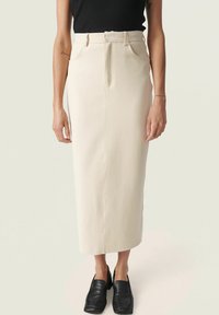 Beige midi-hame, jossa on korkea vyötärö, suora leikkaus ja kaksi etutaskua. Valmistettu teksturoidusta, kevyestä kankaasta.