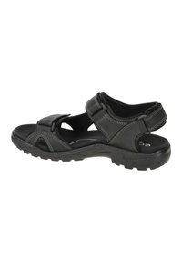 Black sandal with adjustable straps, textured sole, and light stitching accents. Features open sides for ventilation and a cushioned footbed.