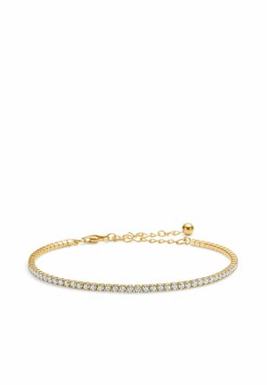 Zlatý náramok s radom čistých kryštálov, pružným dizajnom a predĺženým reťazcom s okrúhlym zapínaním pre nastaviteľnú veľkosť.