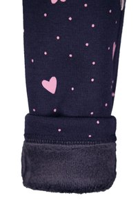 Navy fabric with pink heart and polka dot pattern; features a soft fleece cuff at the hem for added warmth and comfort.