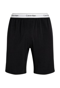 Zwarte katoenen boxershorts met een elastische tailleband, voorzien van een witte "Calvin Klein" logo. Eenvoudig ontwerp met zijnaad en gladde textuur.