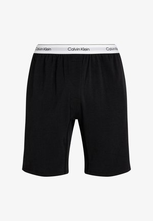 Zwarte katoenen boxershorts met een elastische tailleband, voorzien van een witte "Calvin Klein" logo. Eenvoudig ontwerp met zijnaad en gladde textuur.