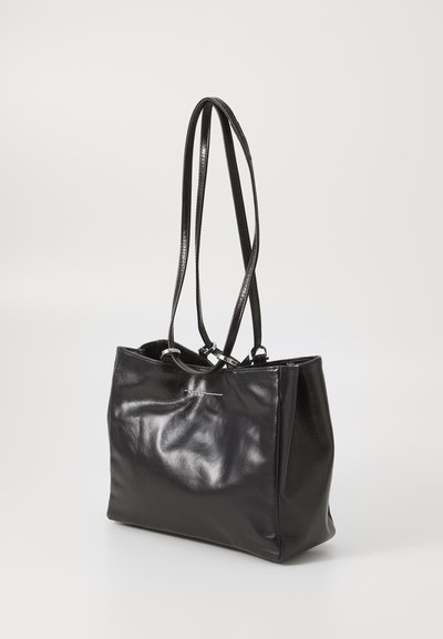Black glossy leather handbag with two long thin straps, slightly wrinkled surface, rectangular shape, and metal hardware on straps.