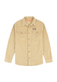 Chemise en velours côtelé beige à manches longues, avec deux poches poitrine, fermeture à boutons et col. Présente une texture à côtes verticales et une étiquette logo.