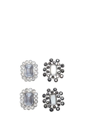 Quatre pièces de bijoux décoratifs, chacune avec une grande pierre centrale rectangulaire claire, deux entourées de petites pierres claires, deux de petites pierres noires.