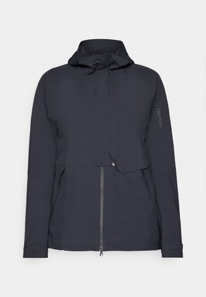 Navy windbreaker jacket featuring a hood, zippered front, and side pockets. Made from smooth, lightweight material with minimal detailing.