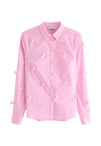 Camicia button-up rosa in cotone con maniche lunghe, caratterizzata da piccoli fiocchi decorativi in tessuto distribuiti uniformemente sulla parte anteriore.