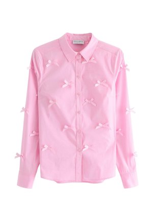 Camicia button-up rosa in cotone con maniche lunghe, caratterizzata da piccoli fiocchi decorativi in tessuto distribuiti uniformemente sulla parte anteriore.