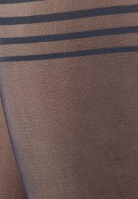Collant marroni con una finitura testurizzata, caratterizzati da tre righe orizzontali blu scuro che attraversano la parte superiore per un tocco di dettaglio in più.