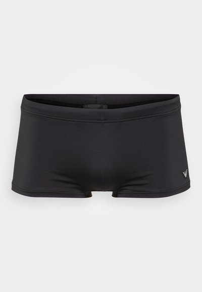 Black swim trunks made of smooth, stretchy fabric. They feature a minimalist design with a small logo on the side and a snug fit.