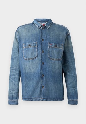 Denim shirt in medium blue, featuring a button-up front, two chest pockets, and a classic collar. Smooth texture with stitching details.