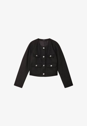 Veste noire courte en tissu texturé avec un col rond, des manches longues, quatre poches devant et des boutons argentés.