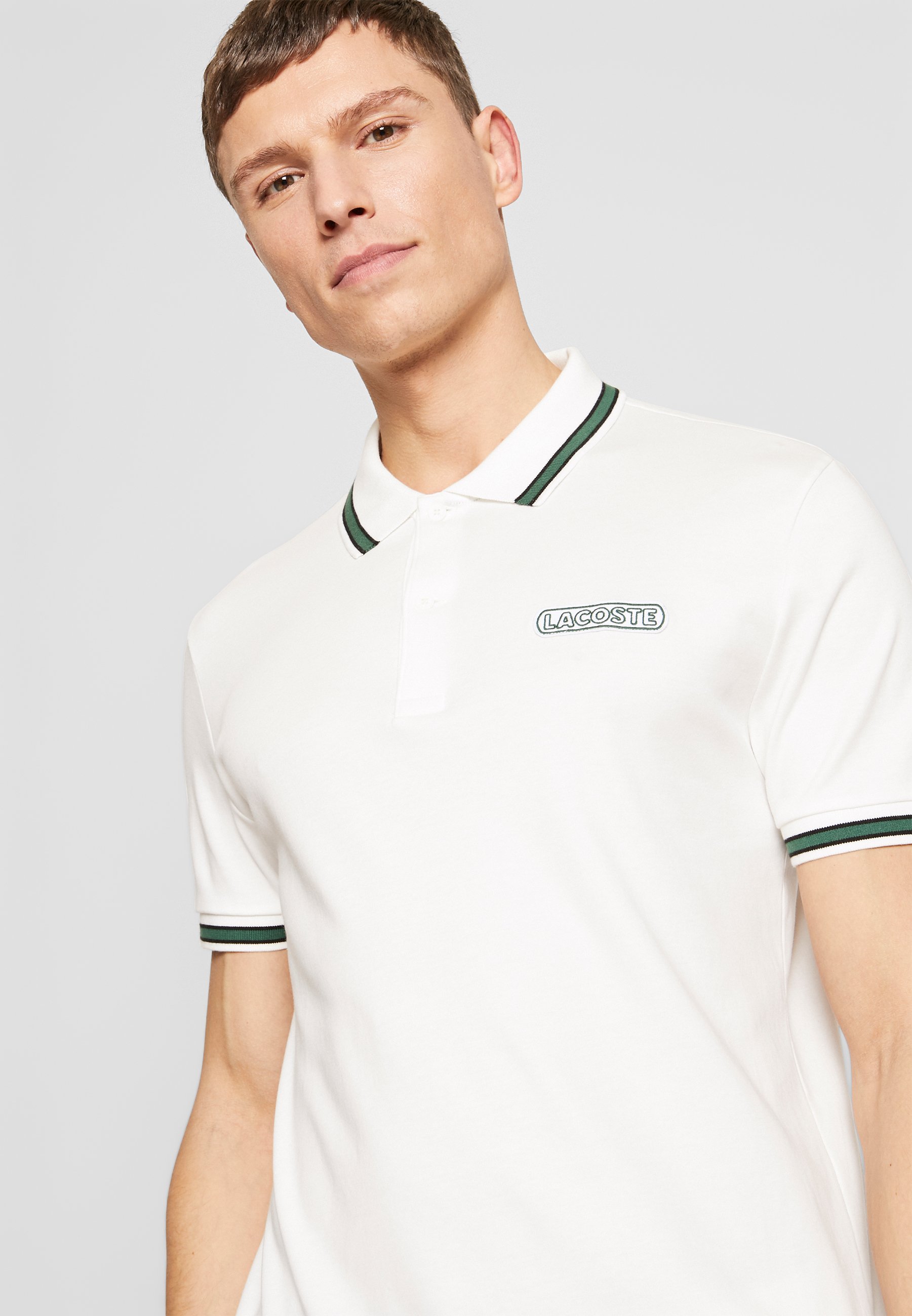 black and green lacoste shirt