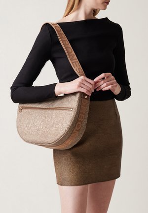 Beige textured shoulder bag with a curved silhouette, featuring a zip pocket, and a branded strap in a contrasting color.