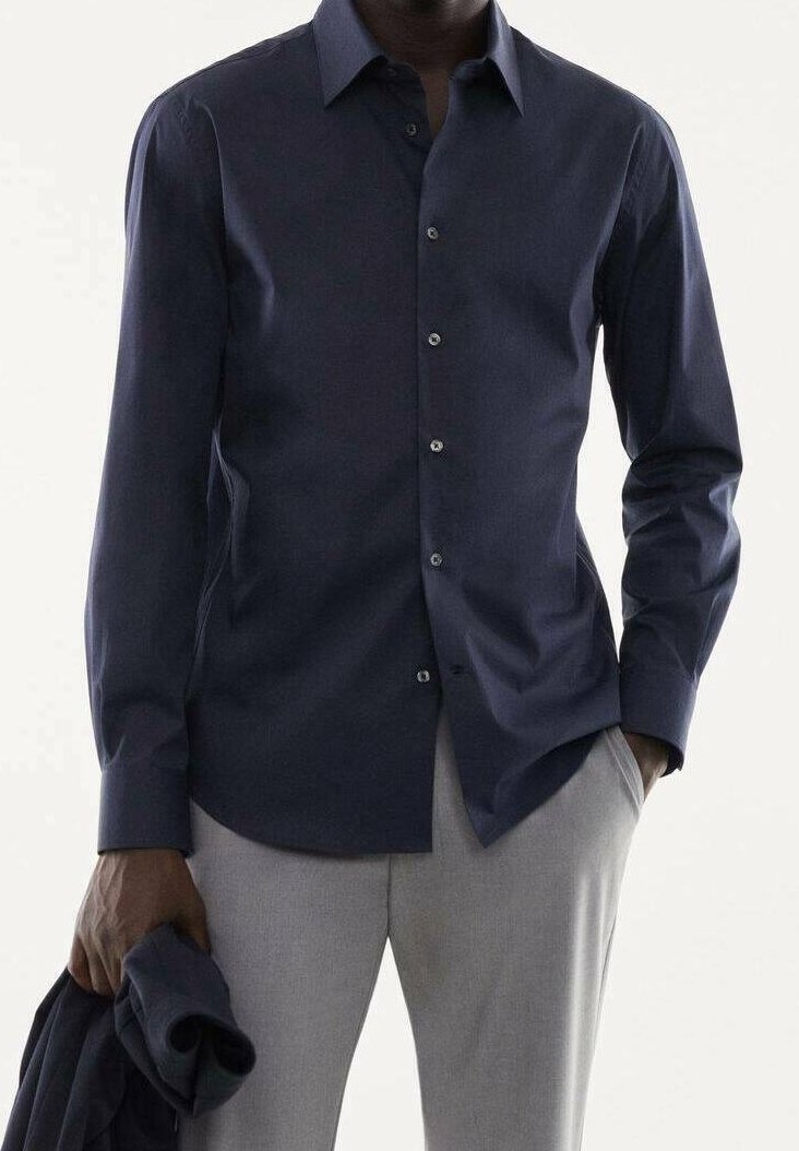 Camicia button-up blu navy con maniche lunghe, realizzata in tessuto liscio, con colletto e chiusura con bottoni classica. Tessuto leggero.