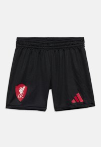 Black athletic shorts with red Liverpool FC crest on left leg and red Adidas logo on right leg, elastic waistband.