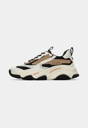 Chunky sneakers with a white, black, and tan color scheme. Features mesh and synthetic materials, a thick sole, and black rubber accents.