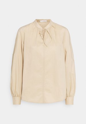 Beige Bluse mit langen Ärmeln aus glattem Stoff, mit rundem Ausschnitt und einer vorderen Bindetail, sowie gerafften Ballonärmeln.