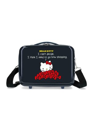 Bolso rectangular negro con Hello Kitty asomándose por encima de una pila de lazos rojos y texto que dice que necesita ir de compras de lazos.