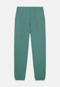 Gröna träningsbyxor med elastisk midja, smalnande ben och mjuk textur. Enkelt design utan mönster eller utsmyckningar.