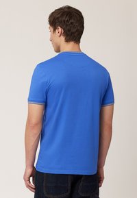 Blue short-sleeve t-shirt with a round neckline, made of soft fabric. Features contrasting trim on sleeves and a smooth, even texture.