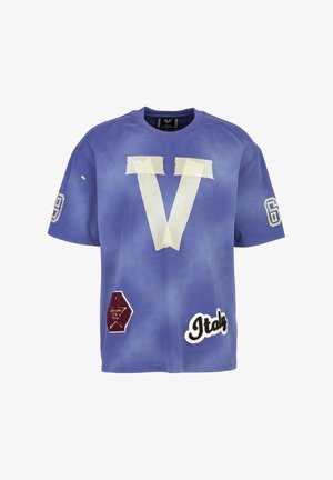 Purple t-shirt featuring a large white "V" with tape markings, number "69," and patches reading "Italy" and a hexagon shape. Cotton material.
