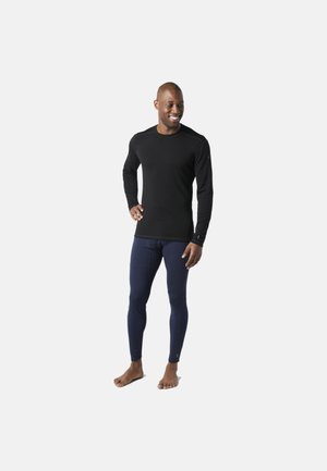 Langærmet sort top og marineblå leggings lavet af glat stof, med et tætsiddende design, uden synlige mønstre eller hardware.