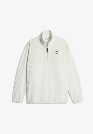 Biały polarowy sweatshirt z zamkiem błyskawicznym w połowie kołnierza, z teksturowaną górną częścią oraz małym czarnym logo Puma na klatce piersiowej.