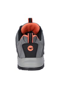 Gray athletic shoe featuring a mesh upper with black accents and an orange interior. Notable elements include a pull tab and logo detail.