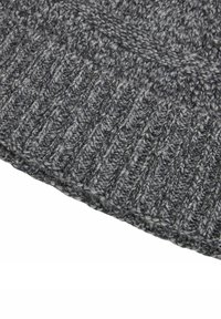 Knitted gray hat featuring a ribbed design, made from textured yarn with light and dark gray strands, showcasing subtle color variations.