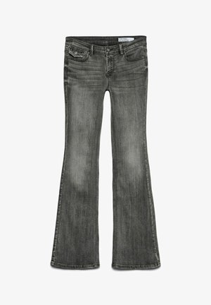 Szare dżinsy w fasonie dzwonów, wykonane z denimu. Posiadają standardowy pas, pięć kieszeni oraz delikatne przetarcia na udach i kolanach.