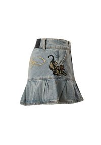 Gonna in denim con orlo svasato, lavaggio azzurro chiaro e ricamo di un gatto con dettagli dorati. Include una vita e una tasca laterale.