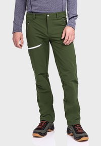 Grüne Outdoor-Hosen aus Stretchgewebe, mit schlanker Passform, Reißverschlusstaschen mit weißen Akzenten und abriebfestem Material.