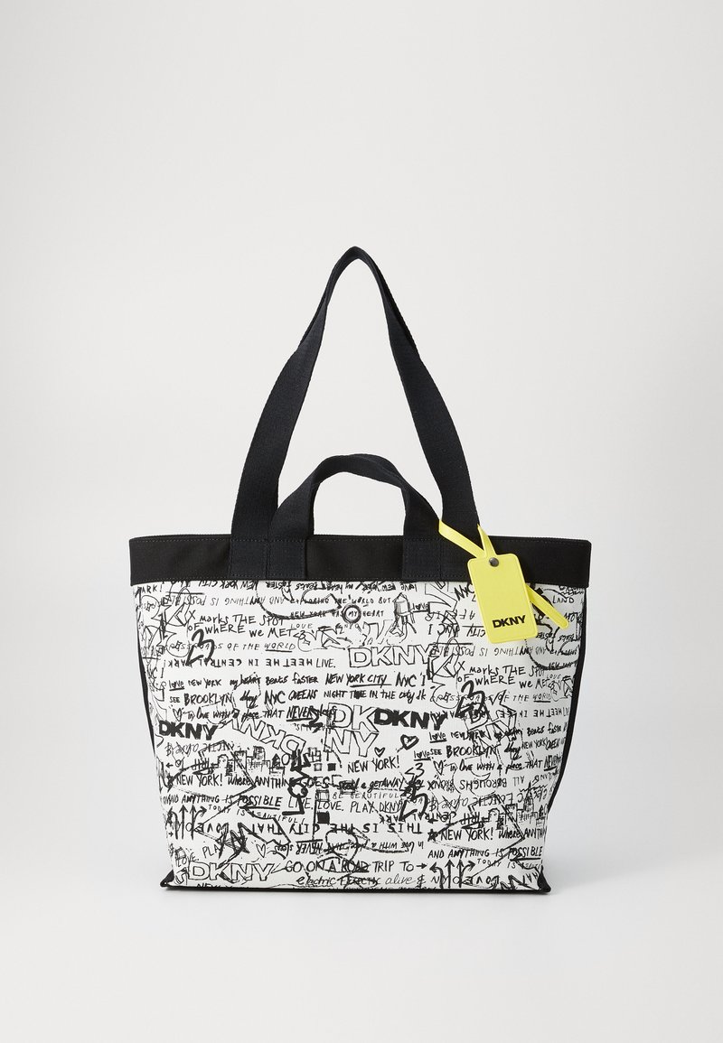 Melnbalta tote soma ar grafisku tekstu un zīmējumiem. Auduma materiāls, divas augšējās rokturi un dzeltena birka kā akcents.