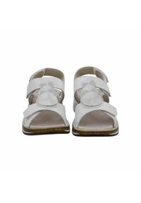 White sandals featuring two adjustable straps, a textured circular accent on the front, open toe design, and a brown sole.