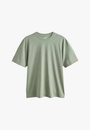 Vihreä puuvillainen T-paita, jossa on pyöreä pääntie, lyhyet hihat ja rento malli. Sileä pinta ilman näkyviä kuvioita tai yksityiskohtia.