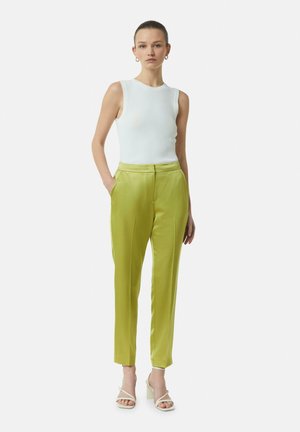 Green satin trousers with a smooth texture, featuring side pockets and a tailored fit. Paired with a white ribbed sleeveless top and sandals.