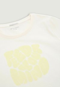 Light-colored cotton T-shirt featuring a round neckline and puffed letters in soft yellow that spell "FEED YOUR MIND."