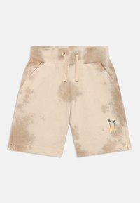 Shorts tie-dye beiges en tissu doux, avec une taille élastique, deux poches et un graphique de palmier en bas à gauche.