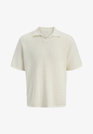 Kortærmet cremefarvet polo-shirt med tekstureret gittermønster og blød krave, vist på en hvid baggrund.