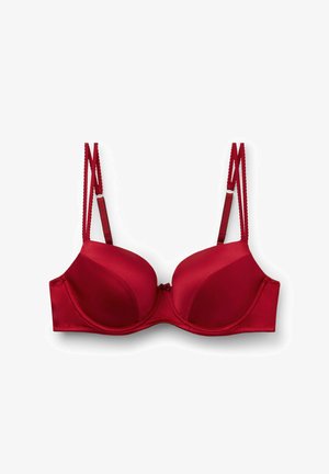 Czerwony stanik z wyściółką, z regulowanymi ramiączkami, gładkim satynowym wykończeniem, wsparciem w postaci fiszbin, detalem w postaci kokardki na środku oraz falbaniastymi krawędziami ramiączek.