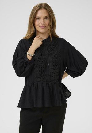 Black blouse with puffed sleeves, button closure, and decorative embroidered panel down the front; peplum hem; soft fabric texture.