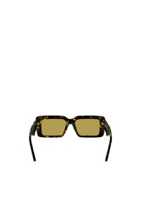 Square sunglasses with a tortoiseshell frame, yellow lenses, and patterned arms. Features a metal hinge detail.