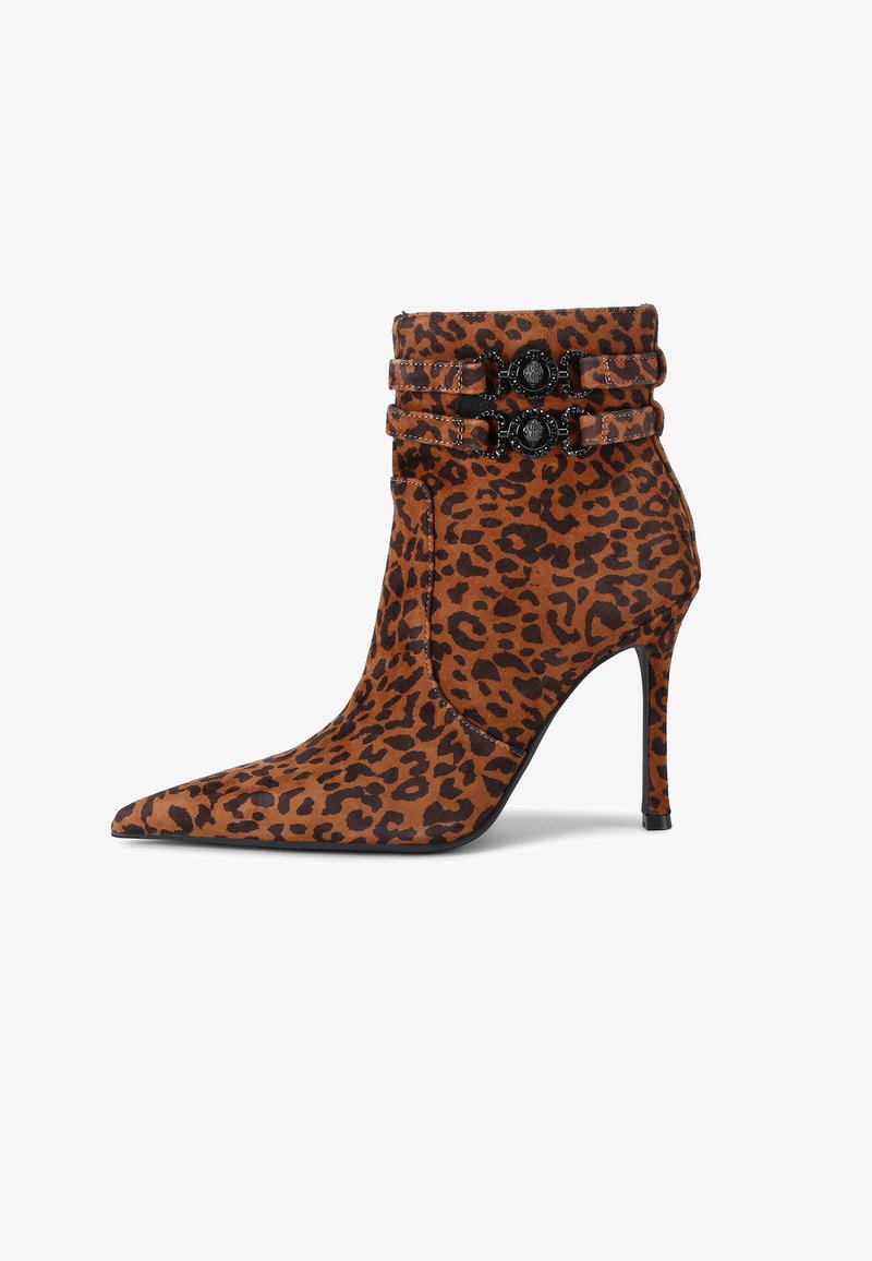 Leopard-print ankle boot made of suede, featuring a pointed toe, stiletto heel, and two decorative black straps with embellishments.