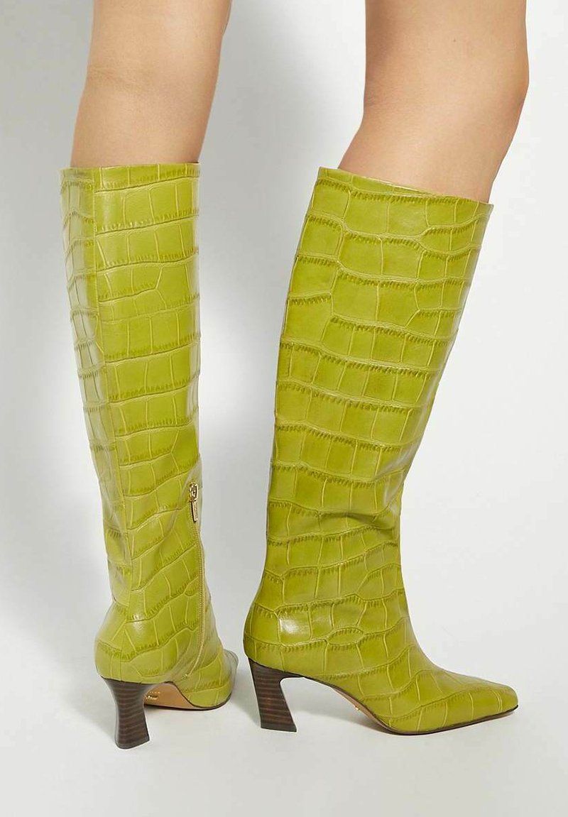Green faux crocodile leather knee-high boots with pointed toe and tapered heel, featuring a zip closure on the side for easy wear.