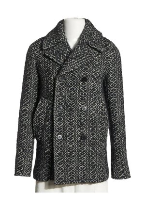 Black and white patterned double-breasted wool coat with wide lapels and six buttons, displayed on a white mannequin torso.
