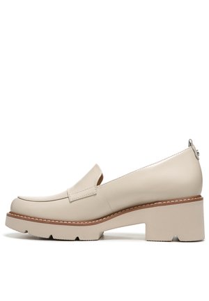 Beige leather slip-on shoe with a rounded toe, low block heel, and decorative stitching along the edge. Textured outsole for grip.